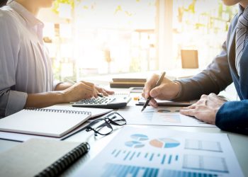 business man financial inspector and secretary making report, calculating or checking balance. Internal Revenue Service inspector checking document. Audit concept